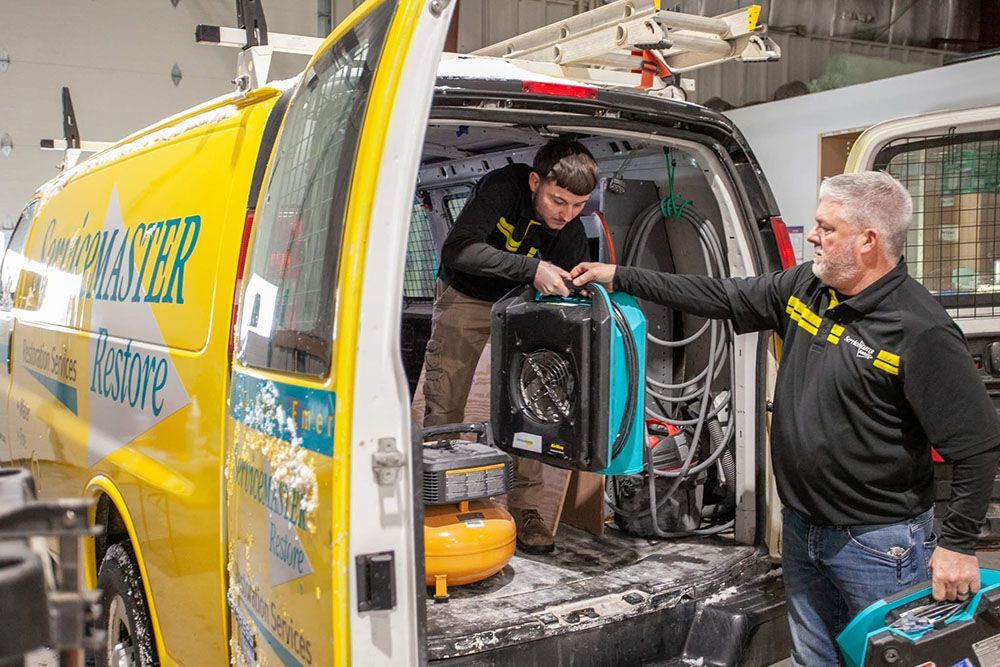 restoration workers in back of van