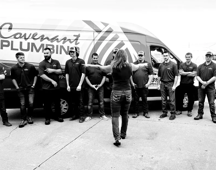 photographer directing a team of plumbers for a team photo