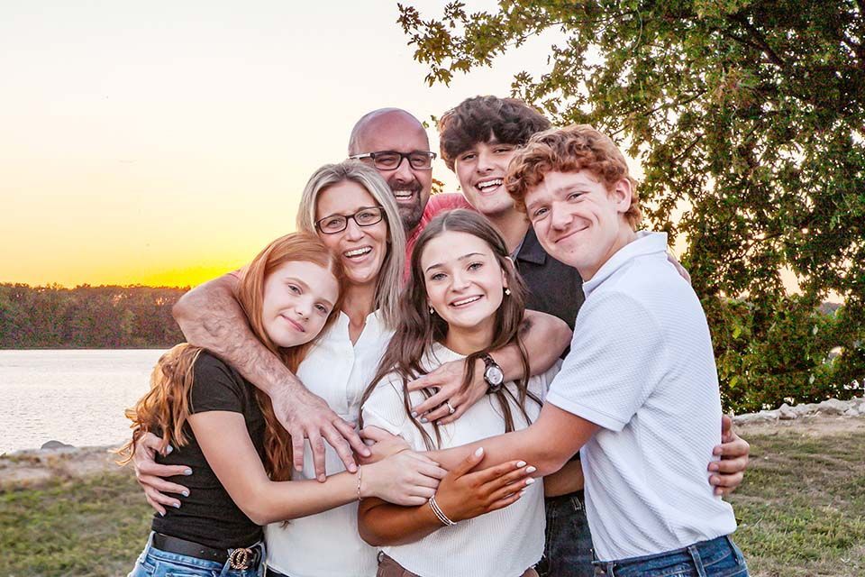 Family hugging in the sunset by Mazter Mindz Media Bloomington IL Photographer