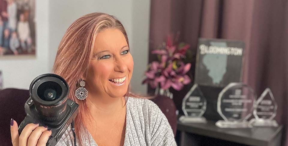 Woman smiling with camera in hand