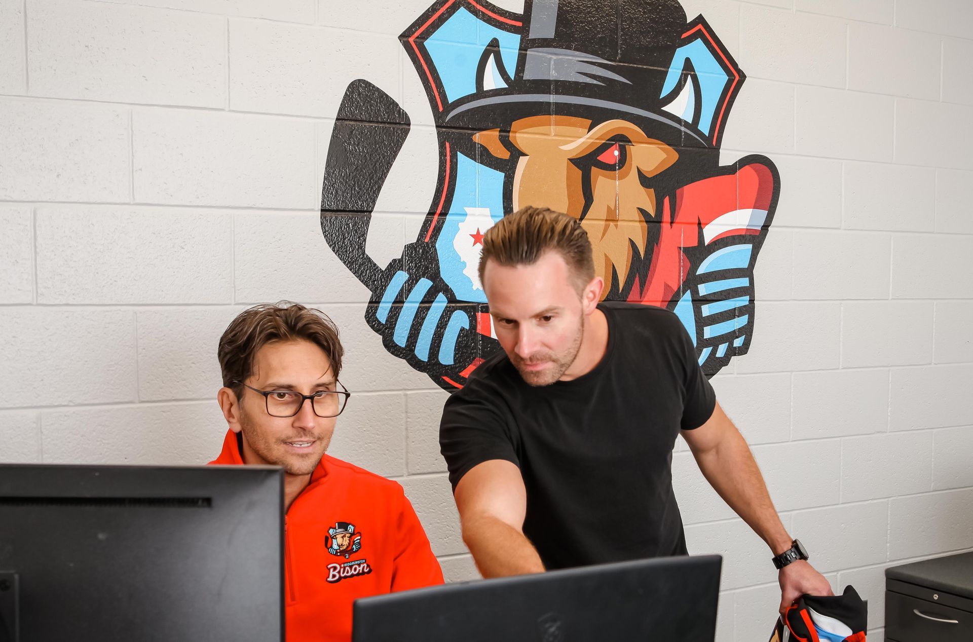two men looking at a computer