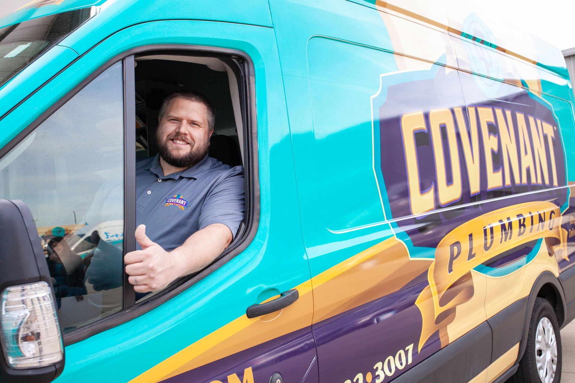 plumber smiling in his van