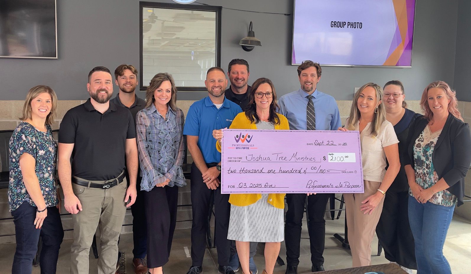 business group presenting a donation check to charity