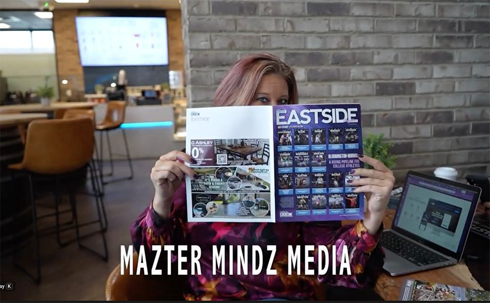 Woman peeking over the top of a magazine