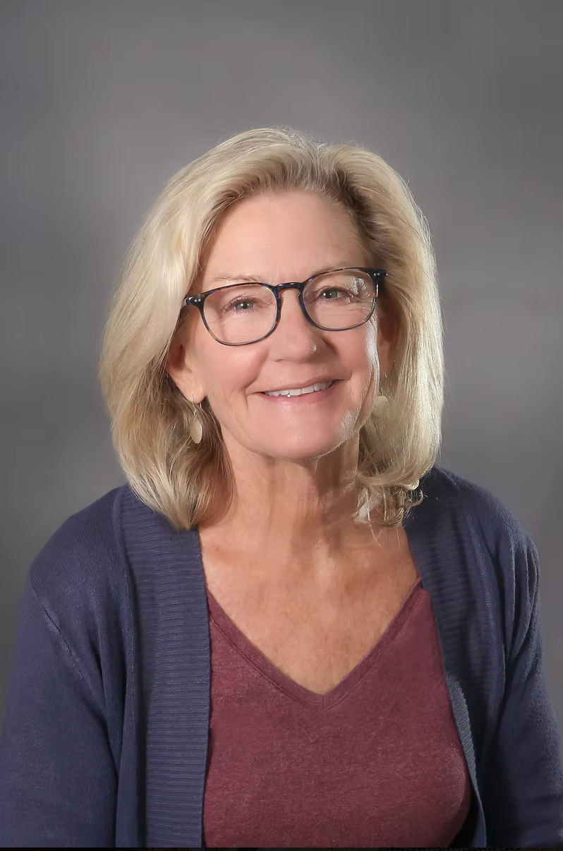 Headshot of a woman on a grey backdrop