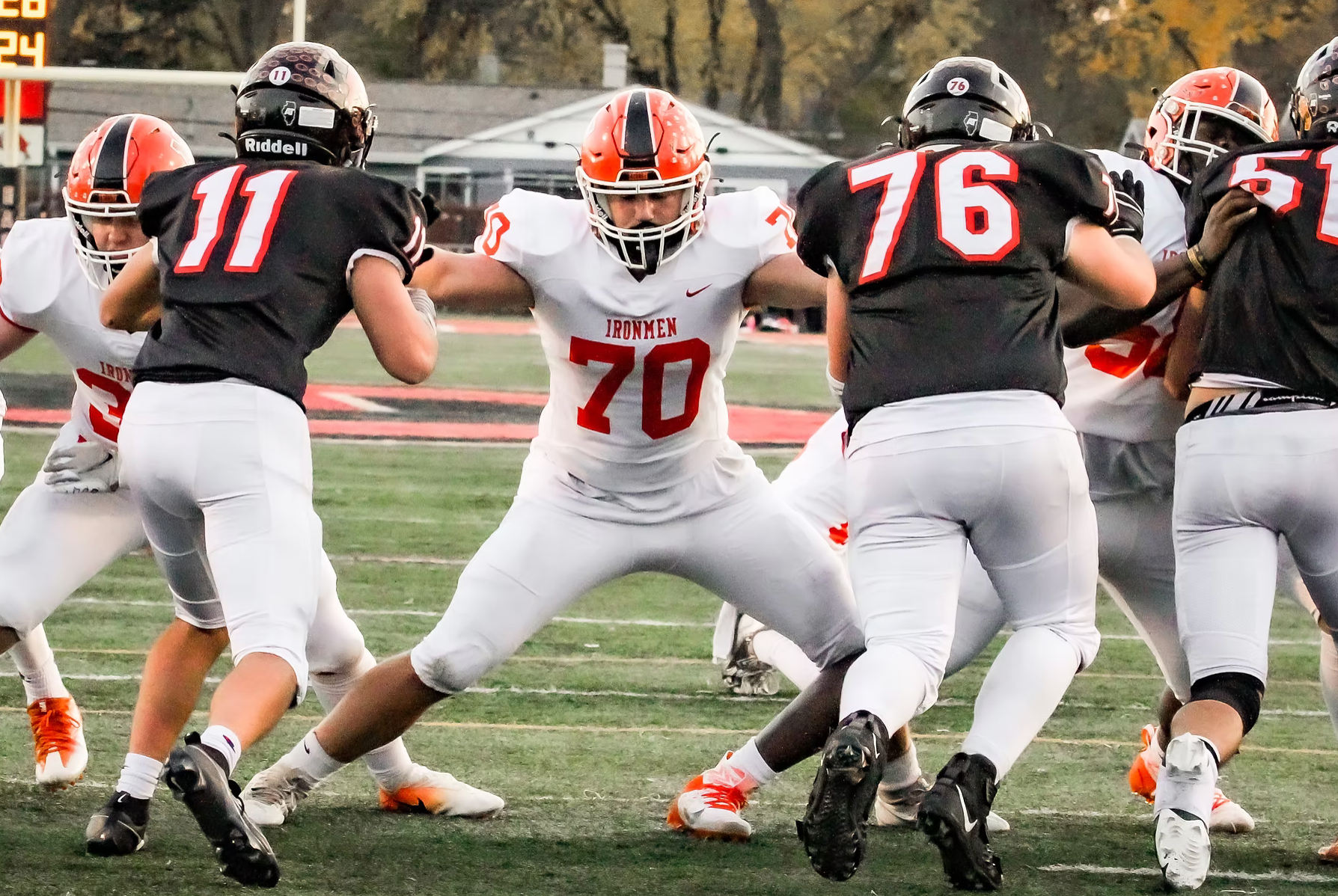 football player holding off defense