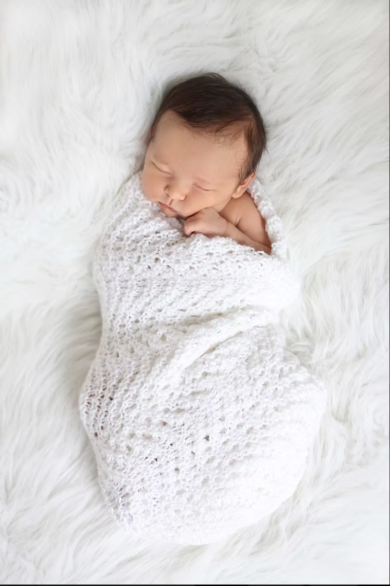 newborn baby wrapped in white blanket