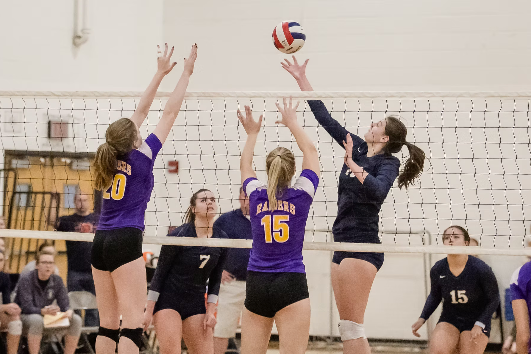 volleyball players battling for the ball
