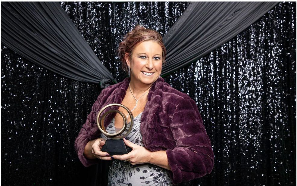 Woman sitting inside a circle of magazines smiling