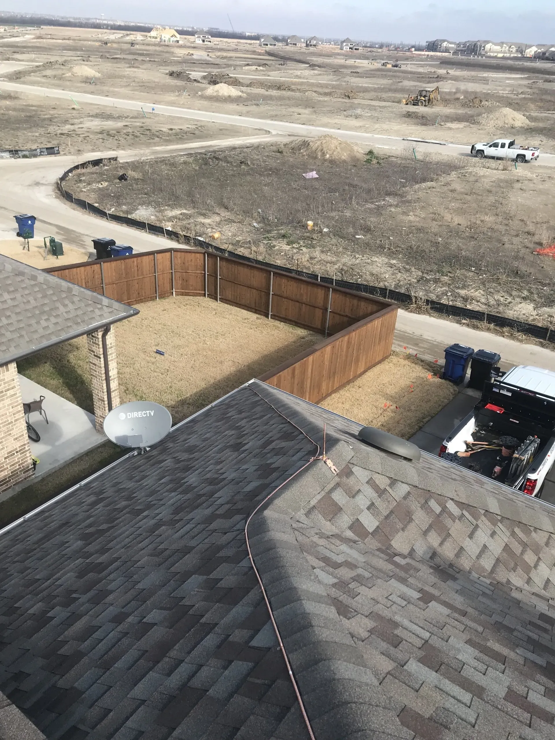 An aerial view of a house with a satellite dish on the roof.