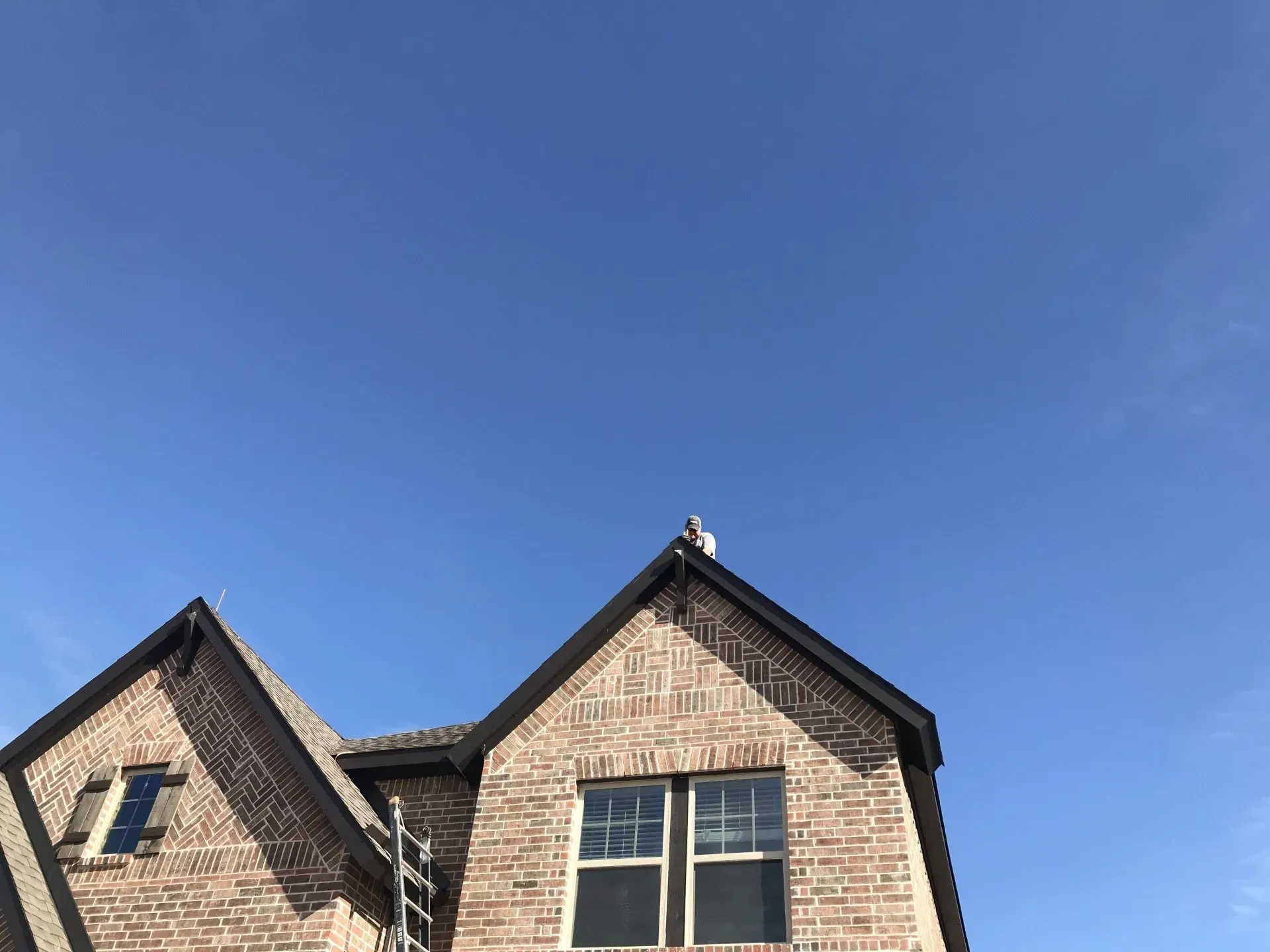 A brick house with a blue sky in the background.