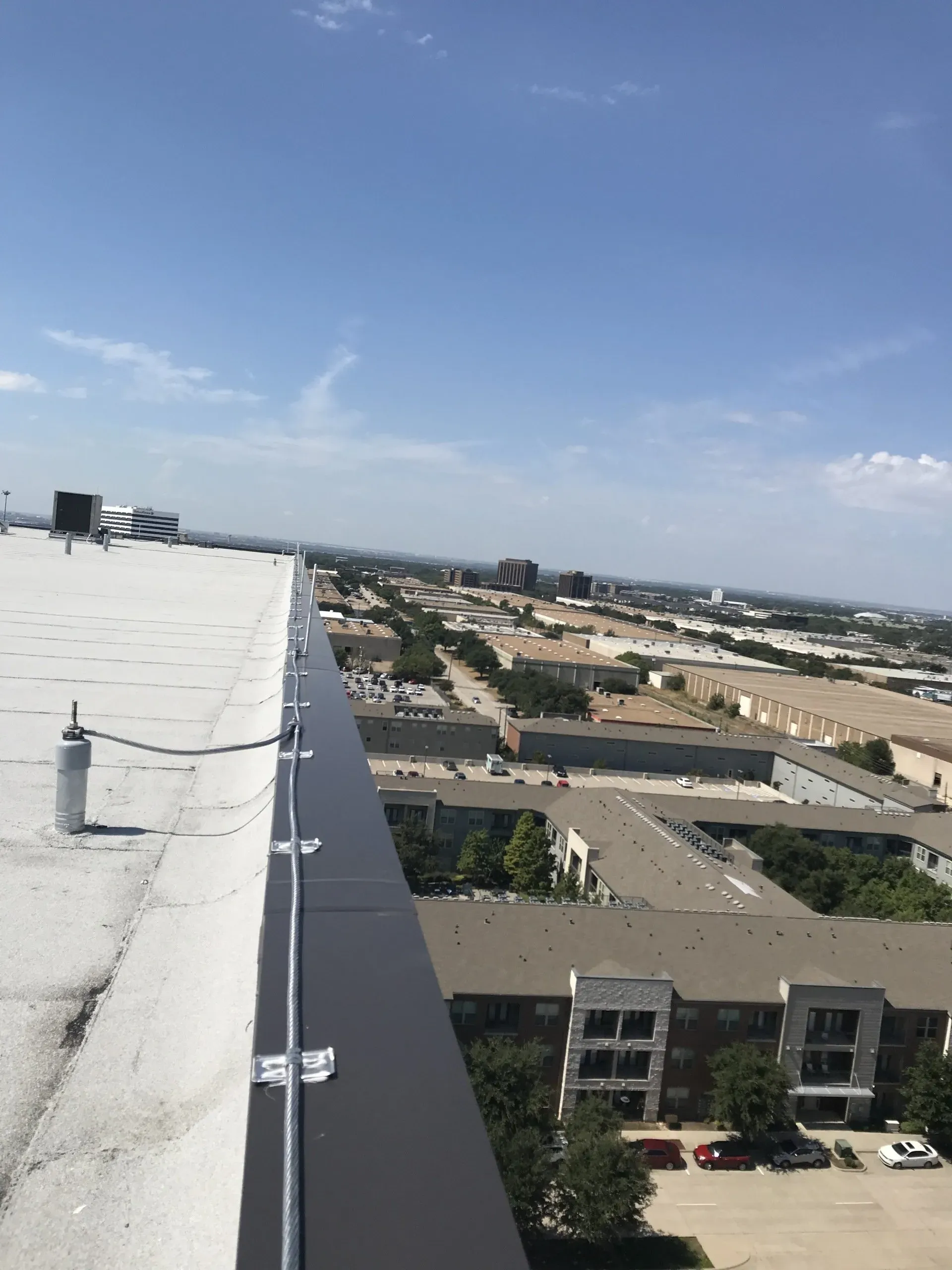 A view of a city from the top of a building.