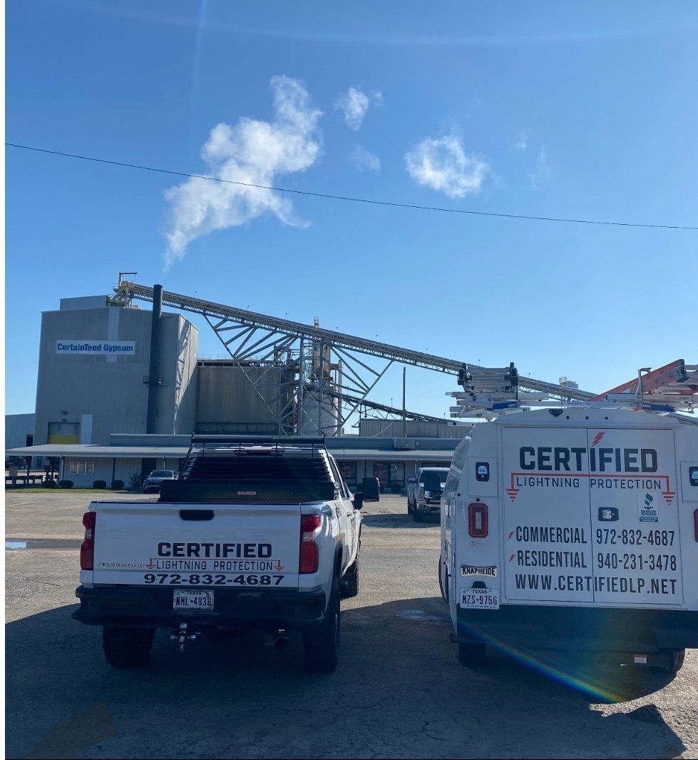 Two certified trucks are parked in a parking lot