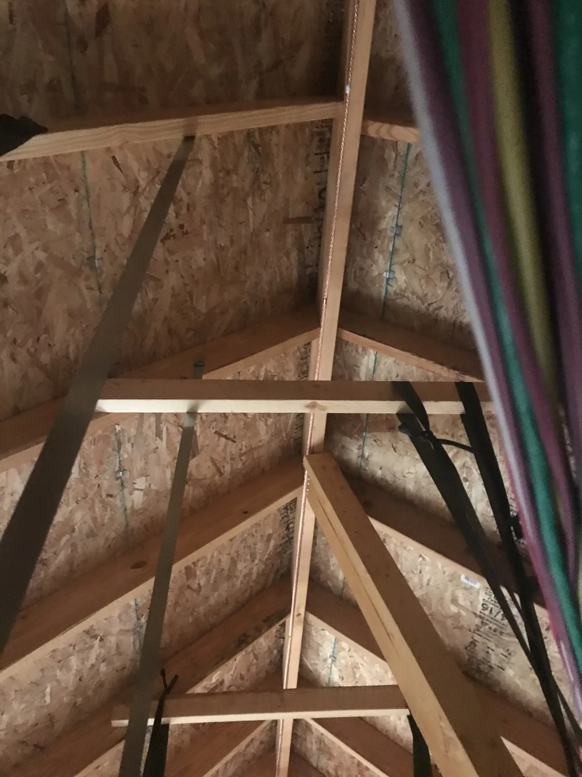 Looking up at the ceiling of a building with wooden beams