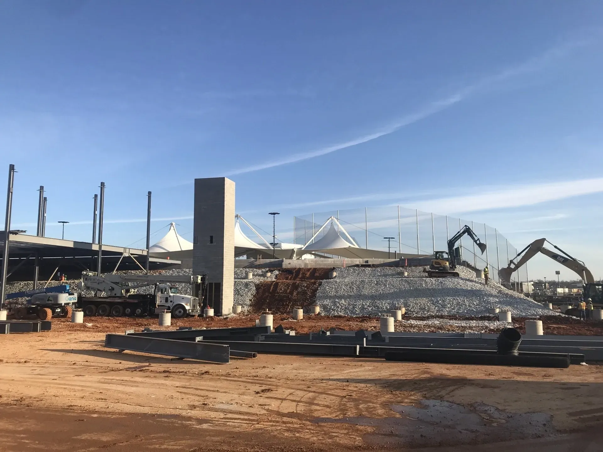 A construction site with a lot of machinery in the background