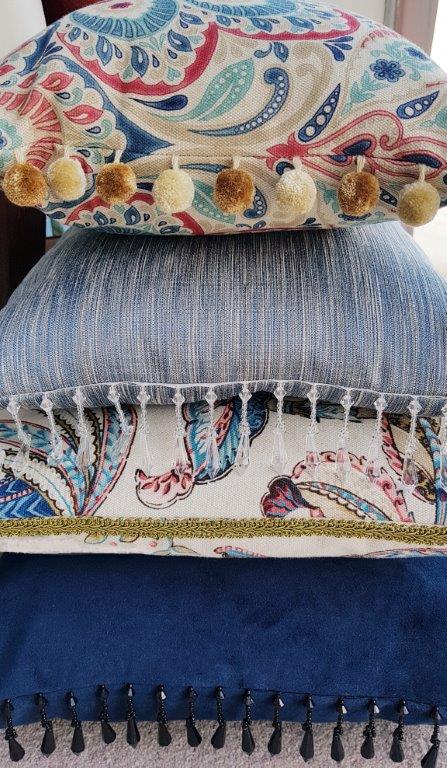 stacked cushions displayed in shop window