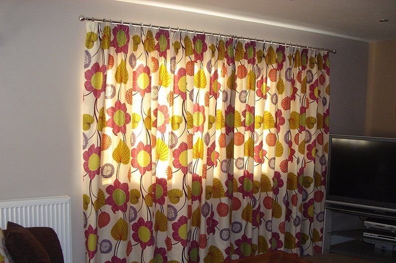 Lovely flowery patterned curtains on window