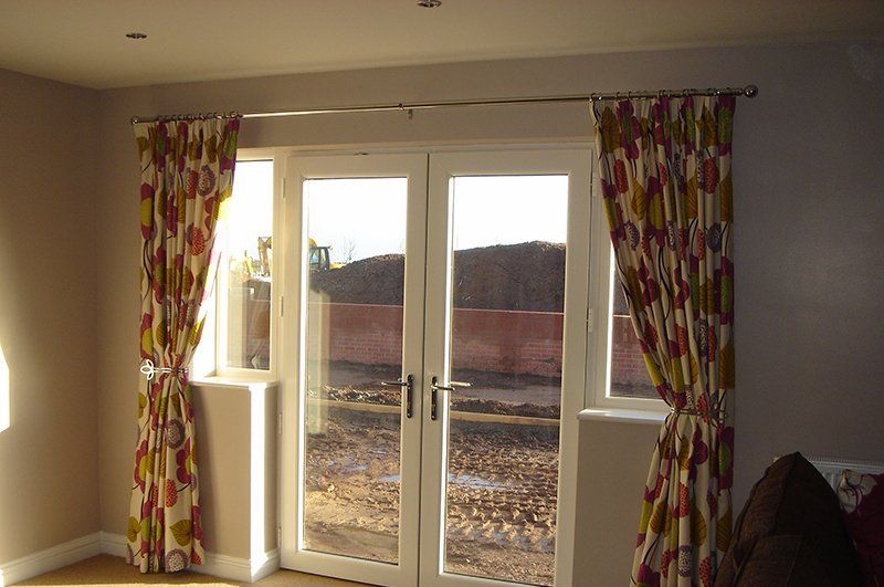 Lovely flowery patterned curtains on patio door