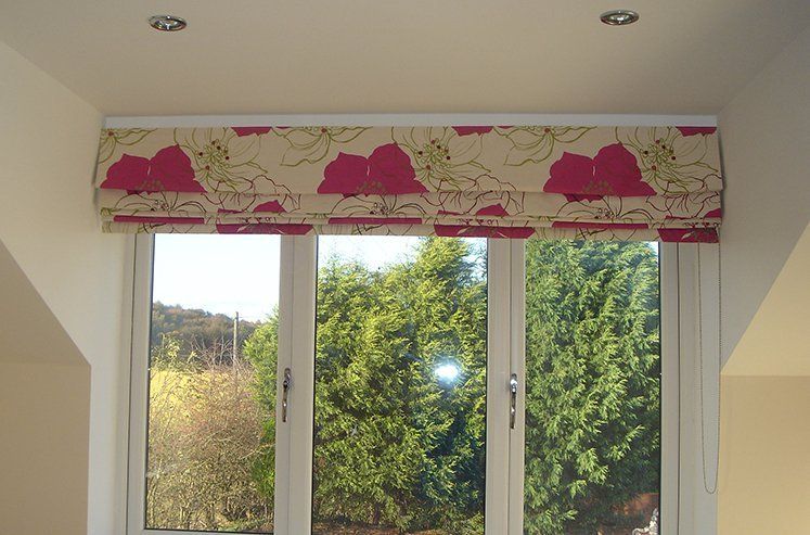 Roman blind in large dark pink flowered fabric