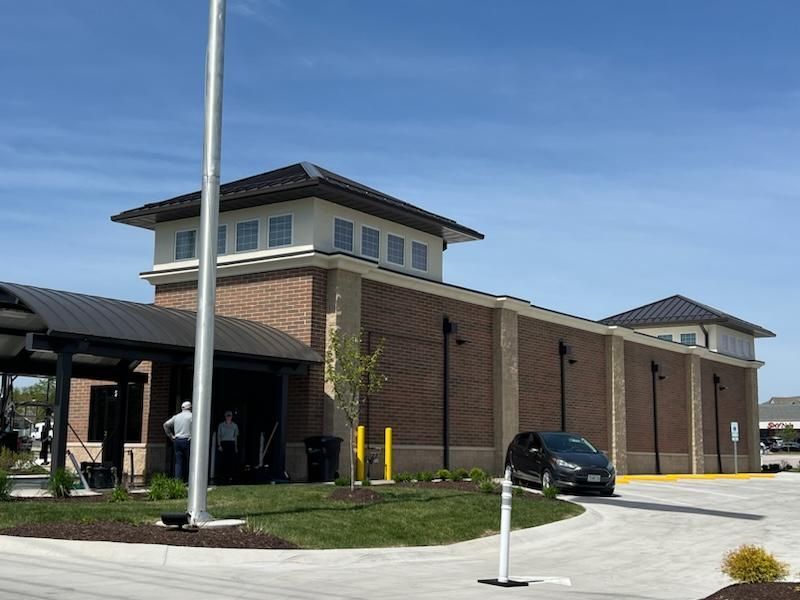 A large brick building with a car parked in front of it