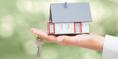 Residential Real Estate — Hand Holding a Miniature House and a Key in Appleton, WI