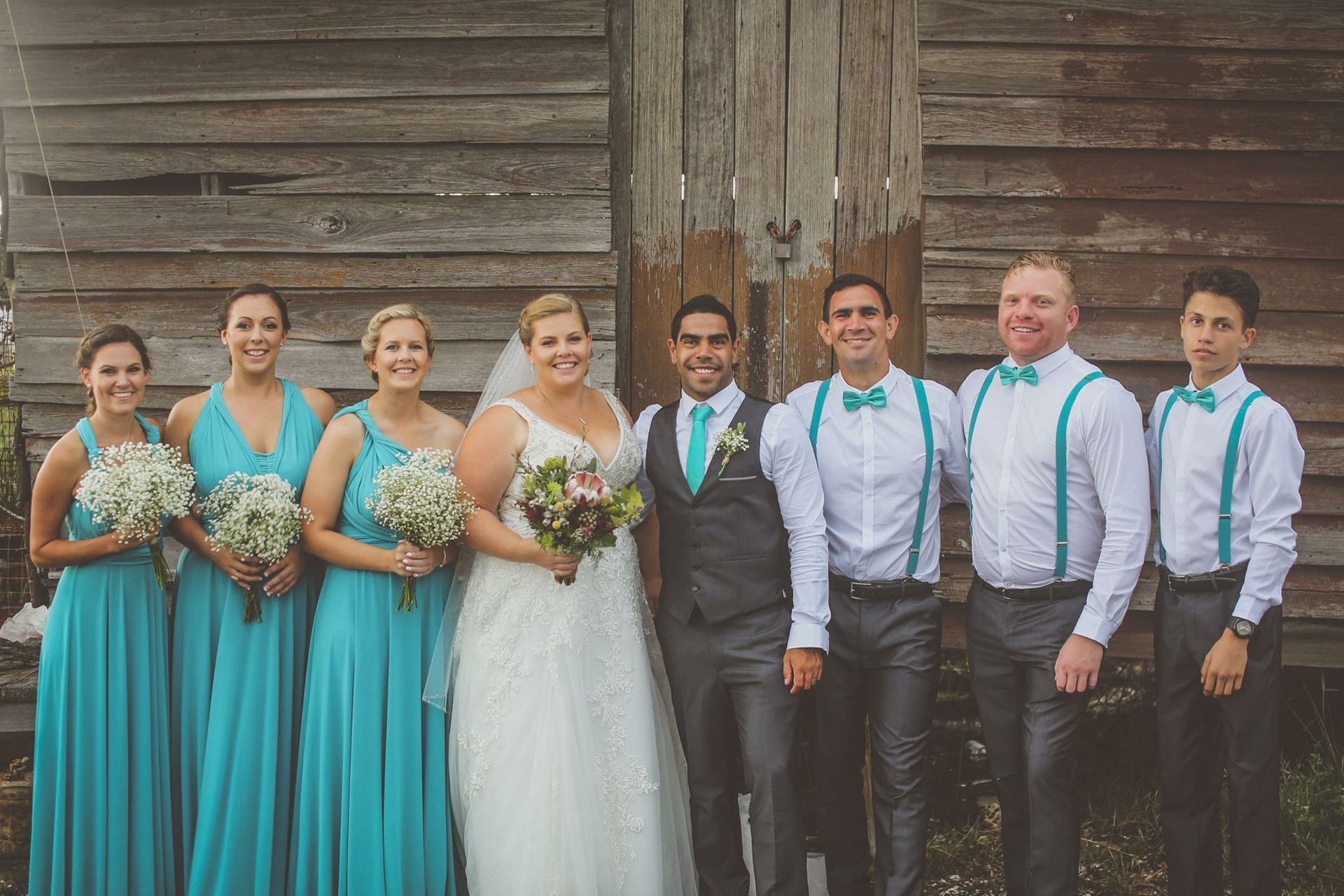 The bride and groom are posing for a picture with their wedding party. — Vanity Skin and Beauty Forster in Forster, NSW