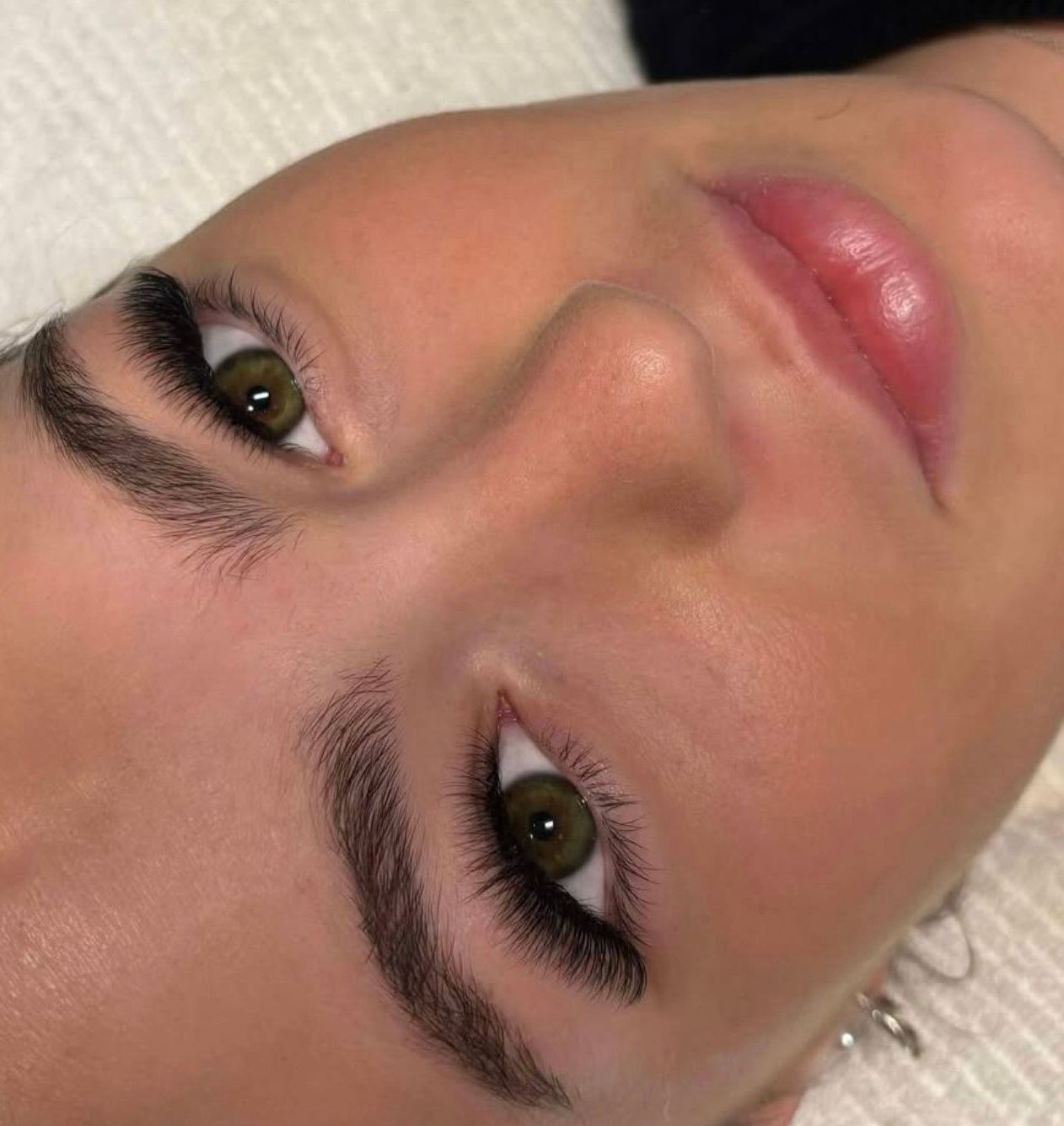 A close up of a woman 's face with green eyes and a pink lip. — Vanity Skin and Beauty Forster in Forster, NSW