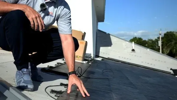 Construction workers in hard hats and vests, looking at a city building site.