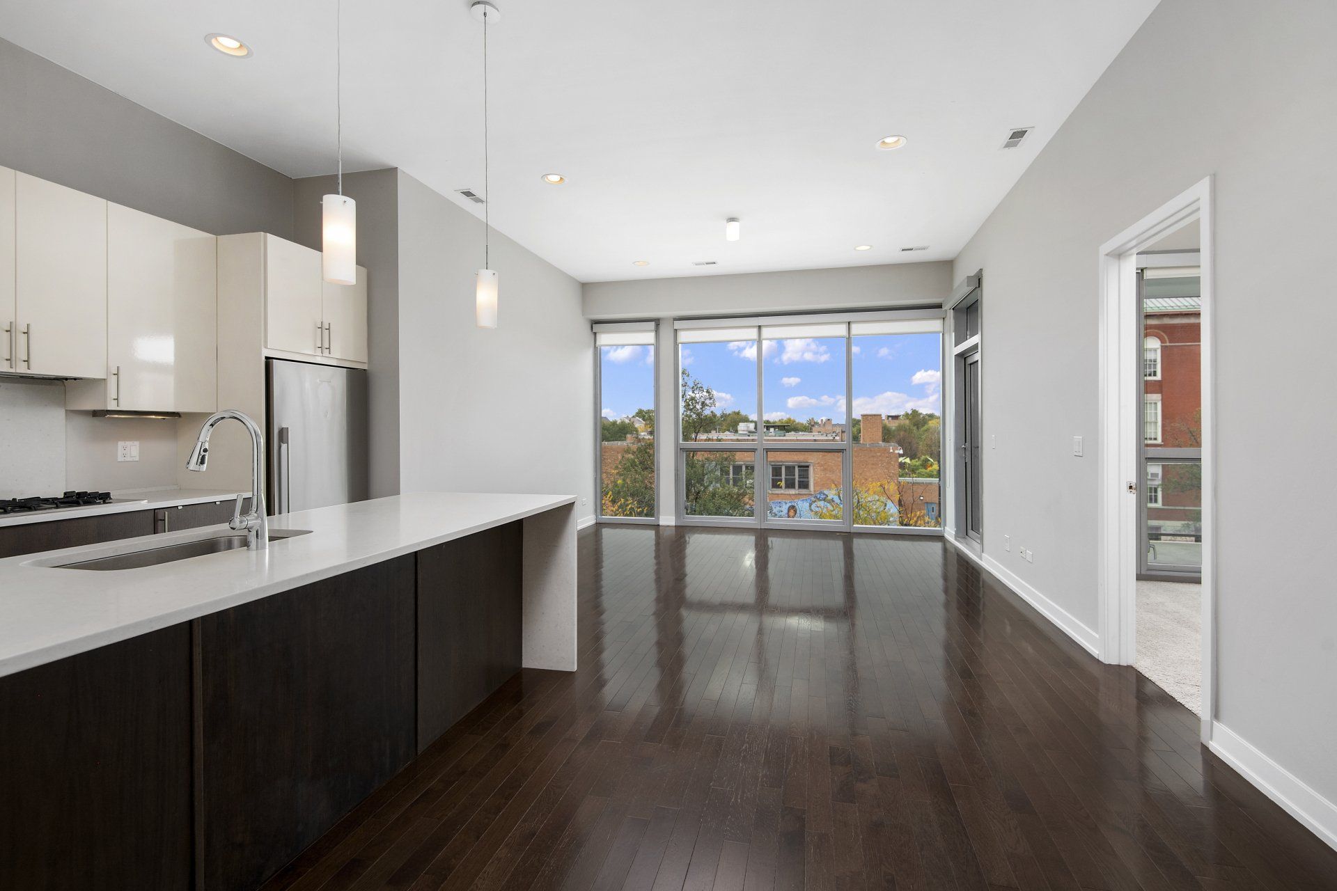 Open floor plan apartment with a kitchen and a large window at 1846 W Division Street.
