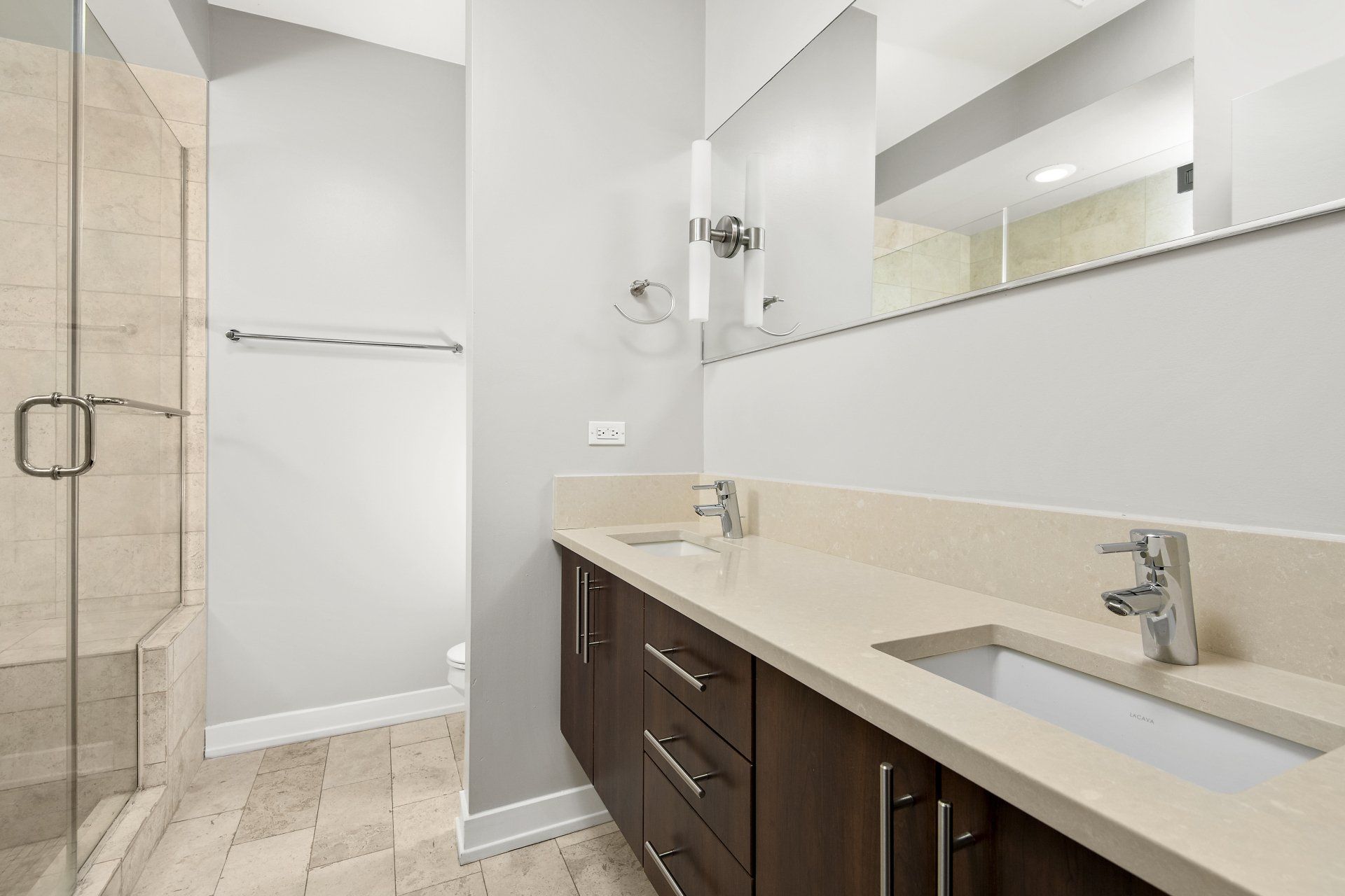 Apartment bathroom with two sinks and a walk-in shower at 1846 W Division Street.