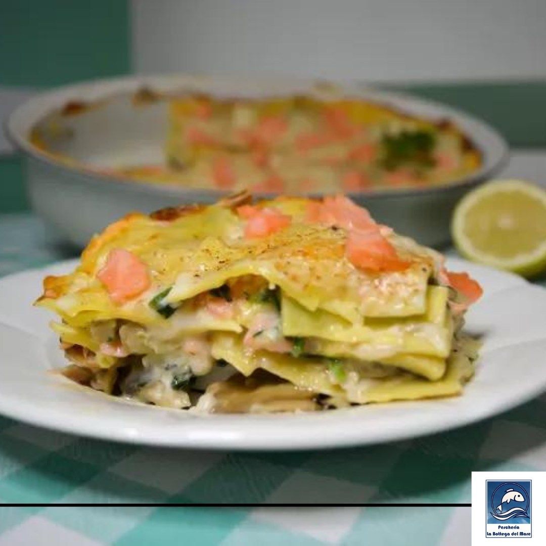 Un piatto bianco con una fetta di lasagna sopra