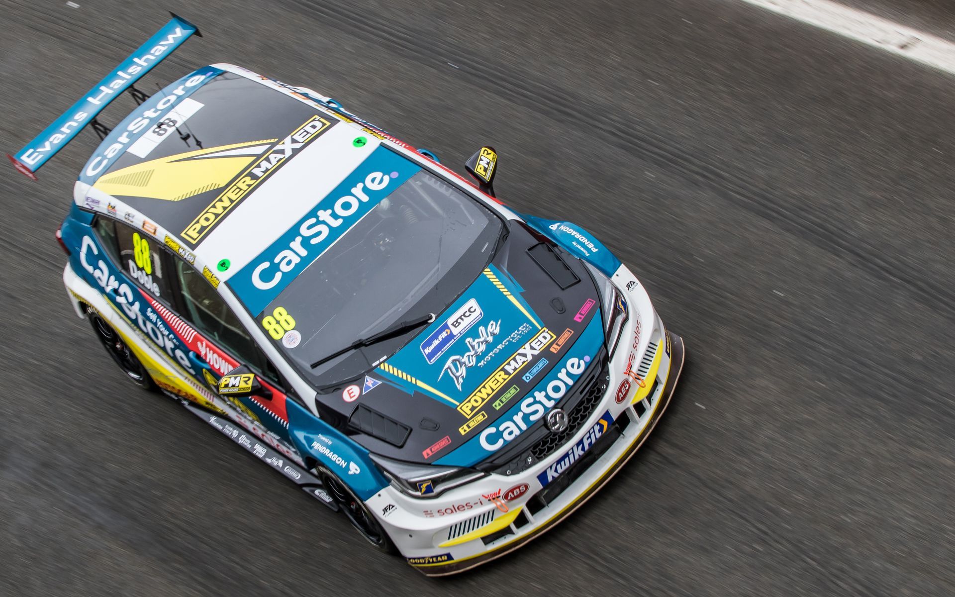 A race car is driving down a race track.