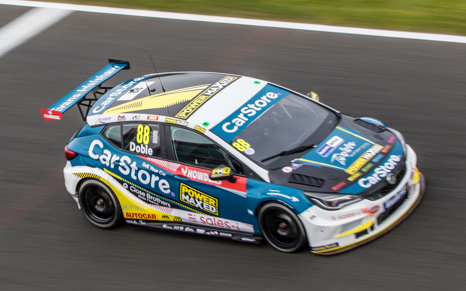 A race car is driving down a race track.