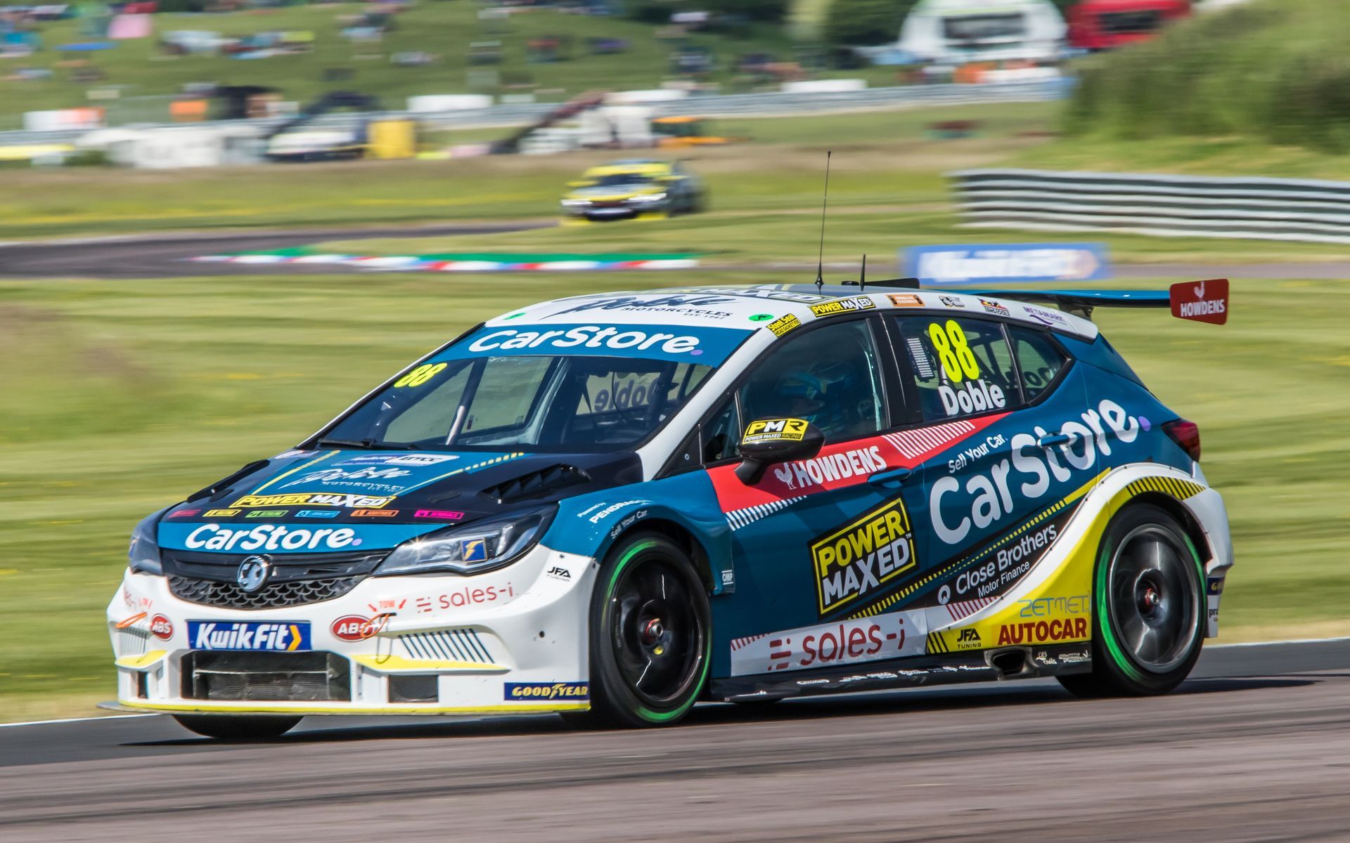 A race car is driving down a race track.