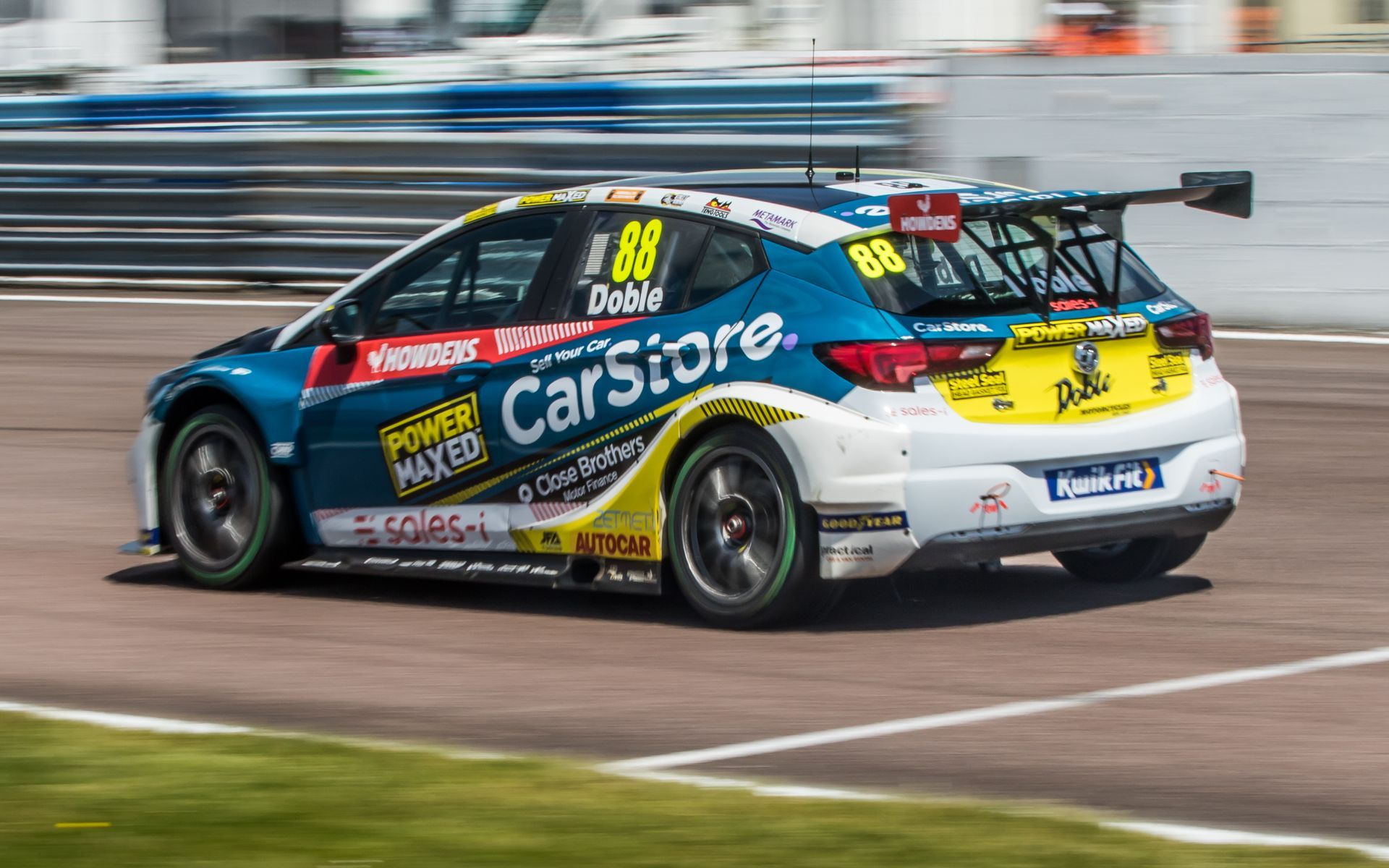 A race car is driving down a race track.