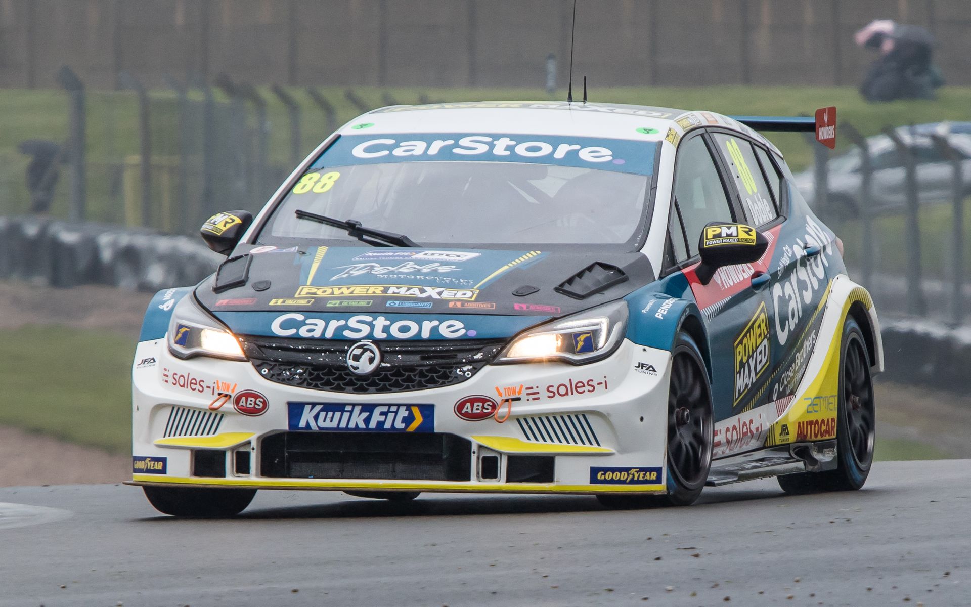 A race car is driving down a race track.