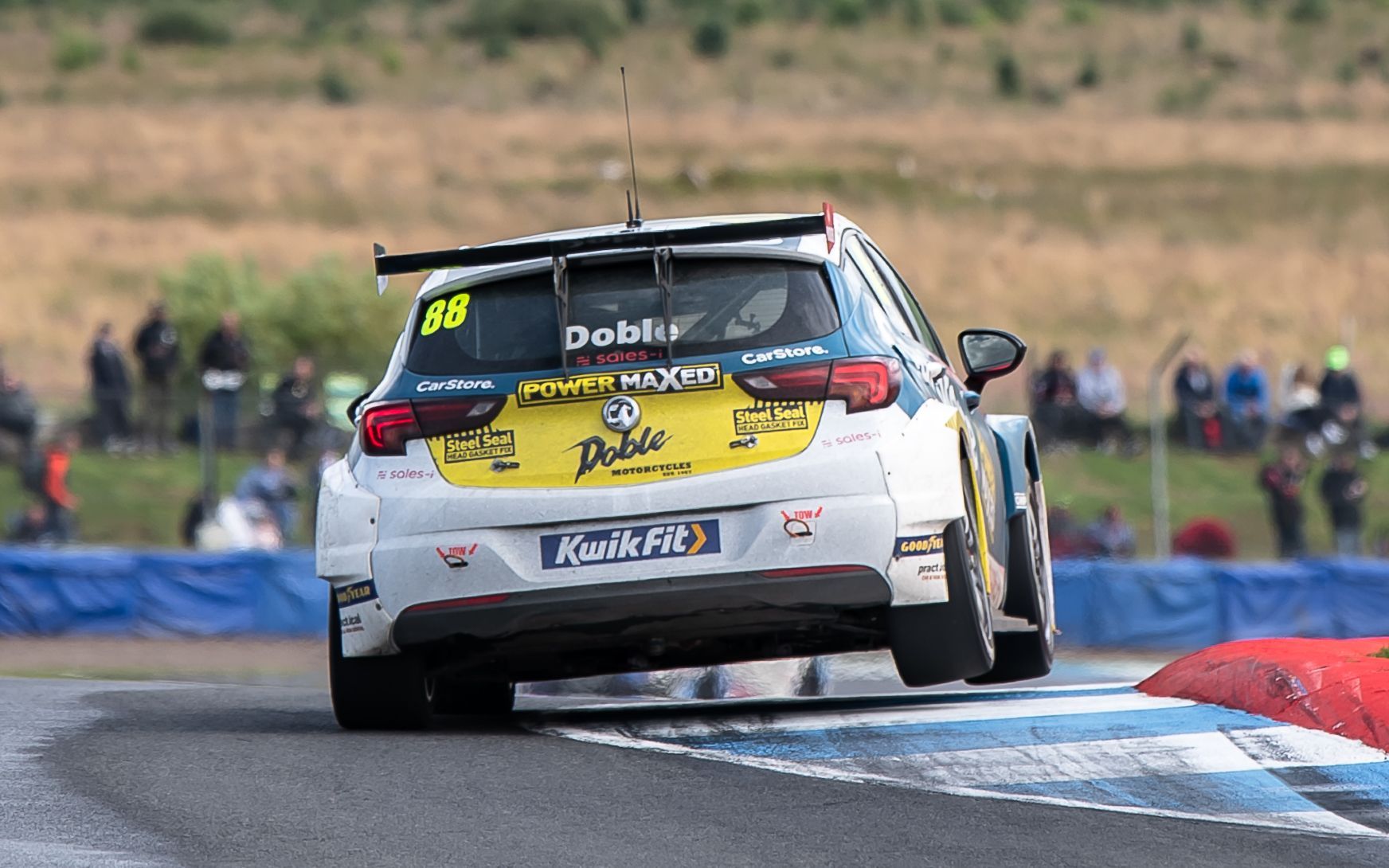 A race car is driving down a race track.