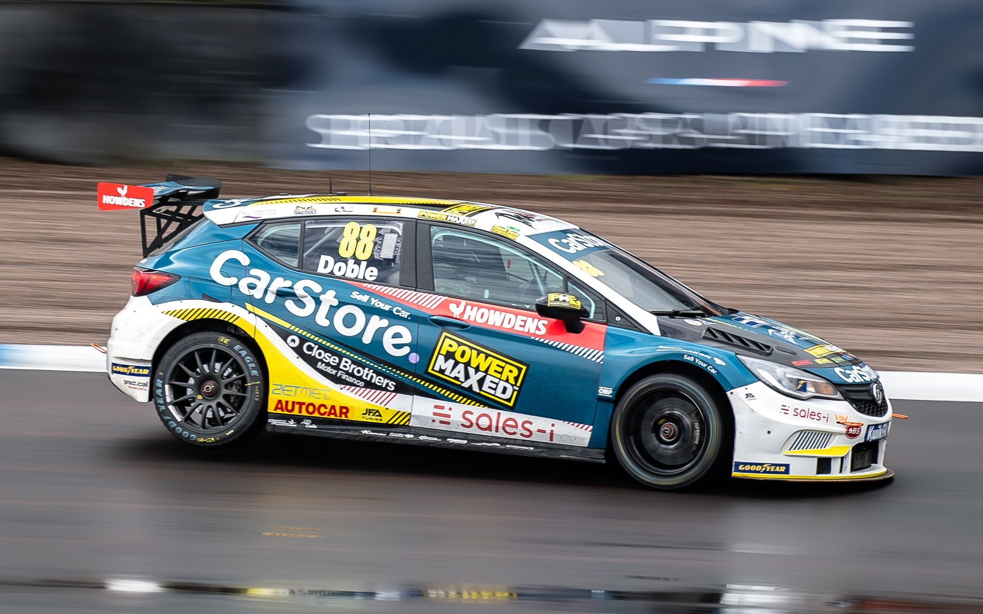 A race car is driving down a race track.