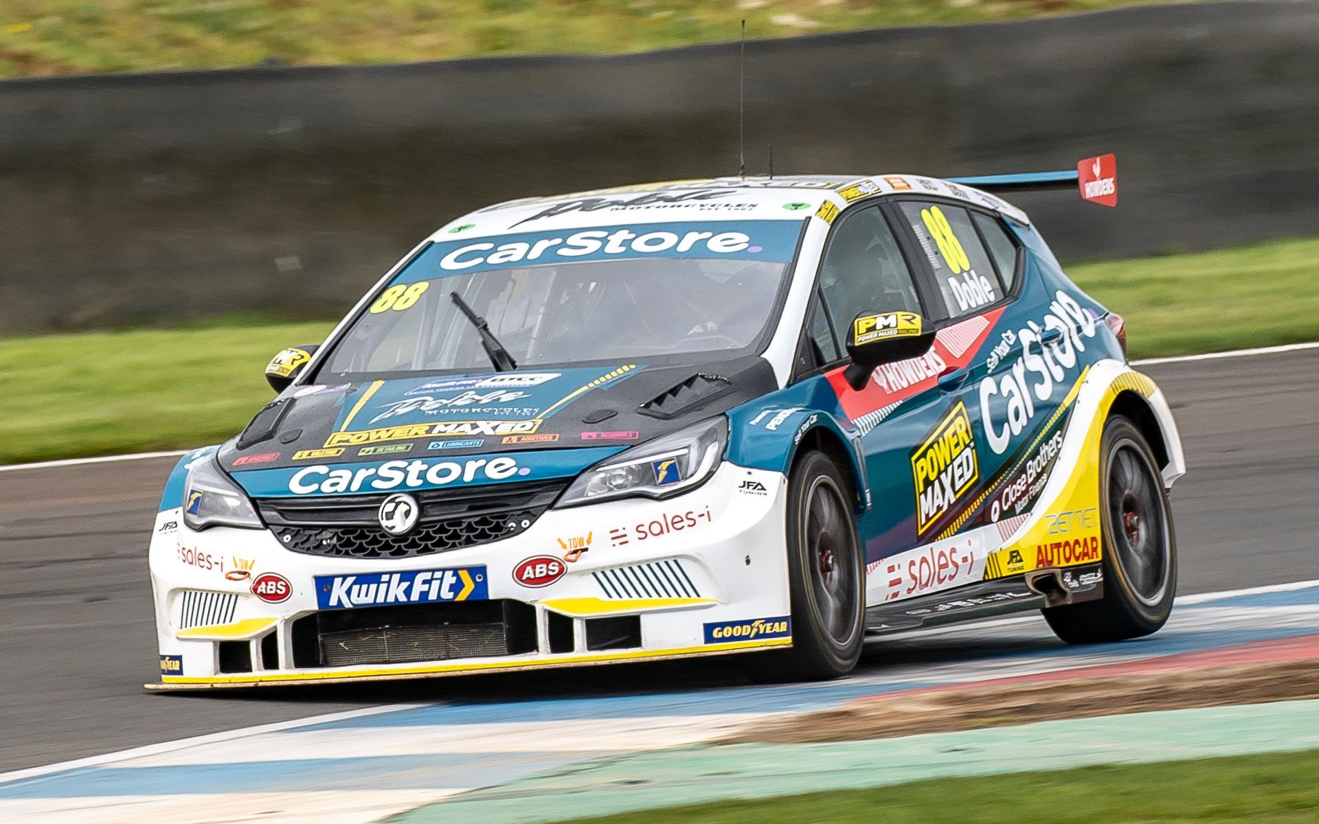 A race car is driving down a race track.