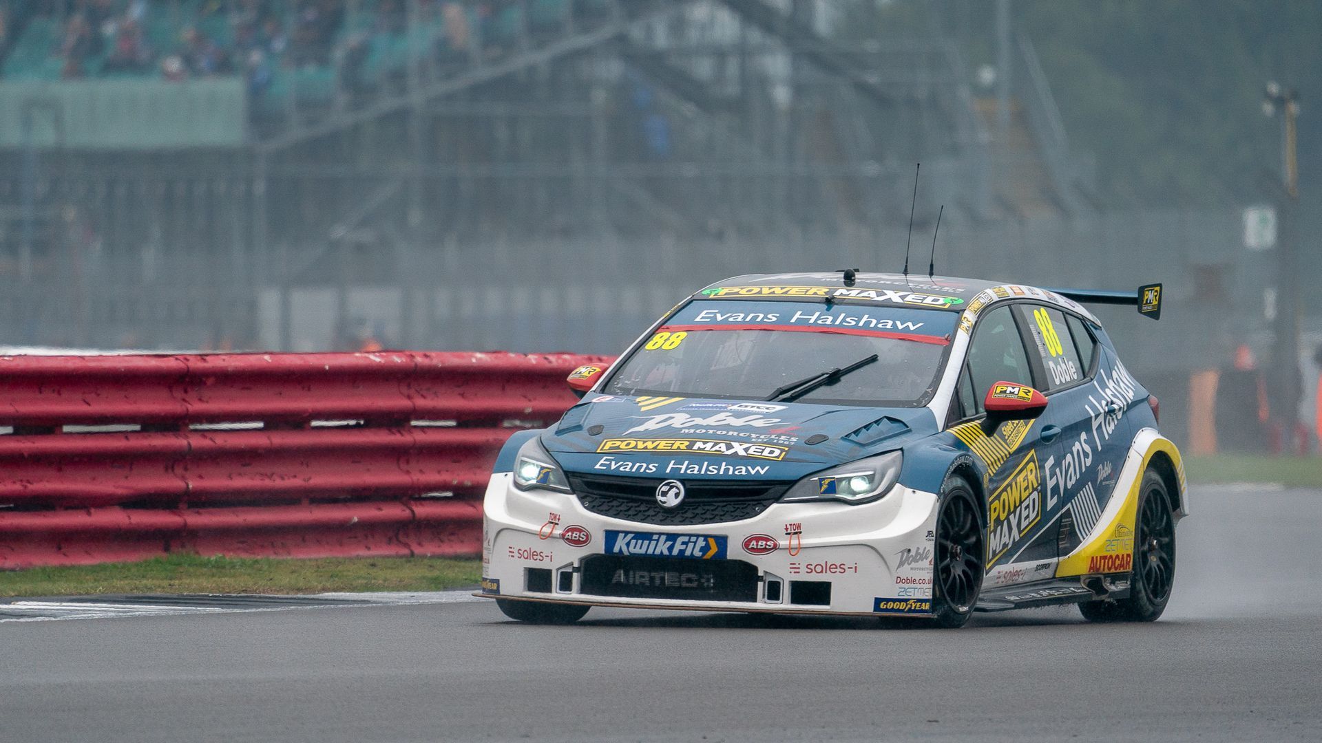 A race car is driving down a race track.