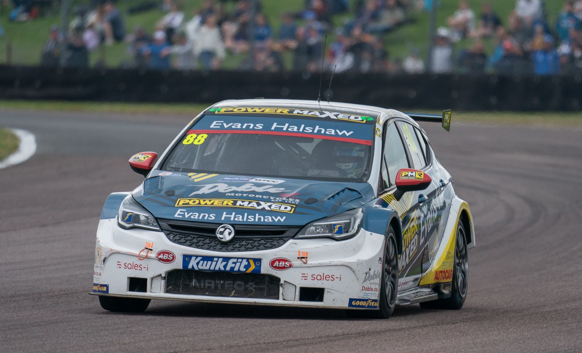 A race car is driving down a race track.