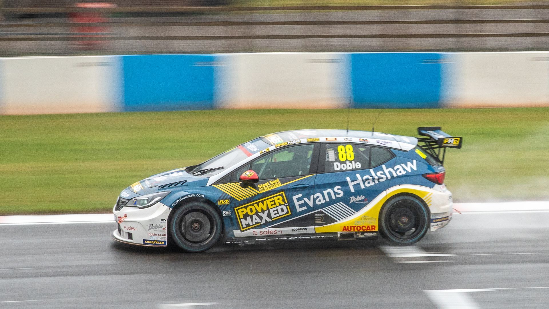 A race car is driving down a race track.