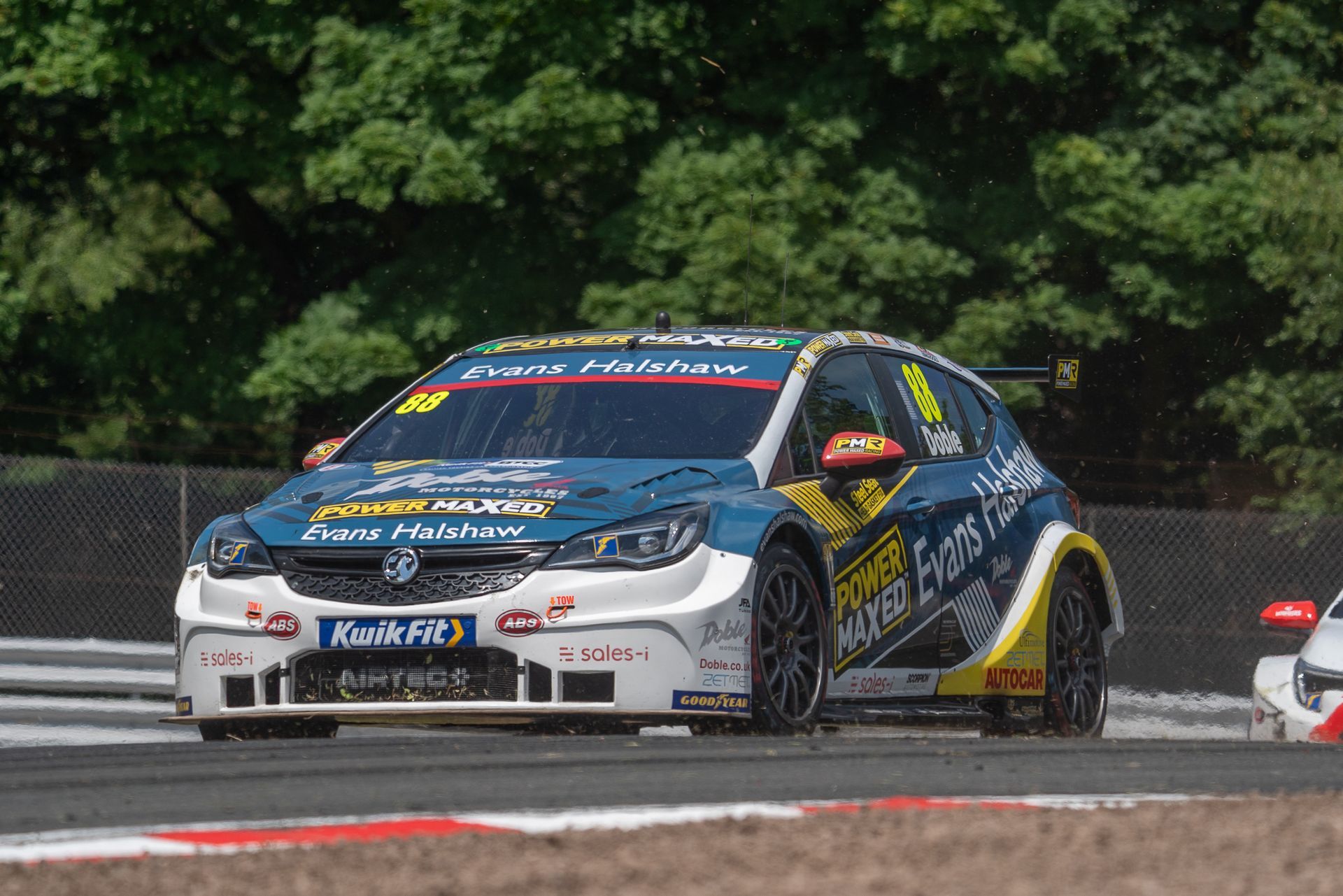 A race car is driving down a race track.