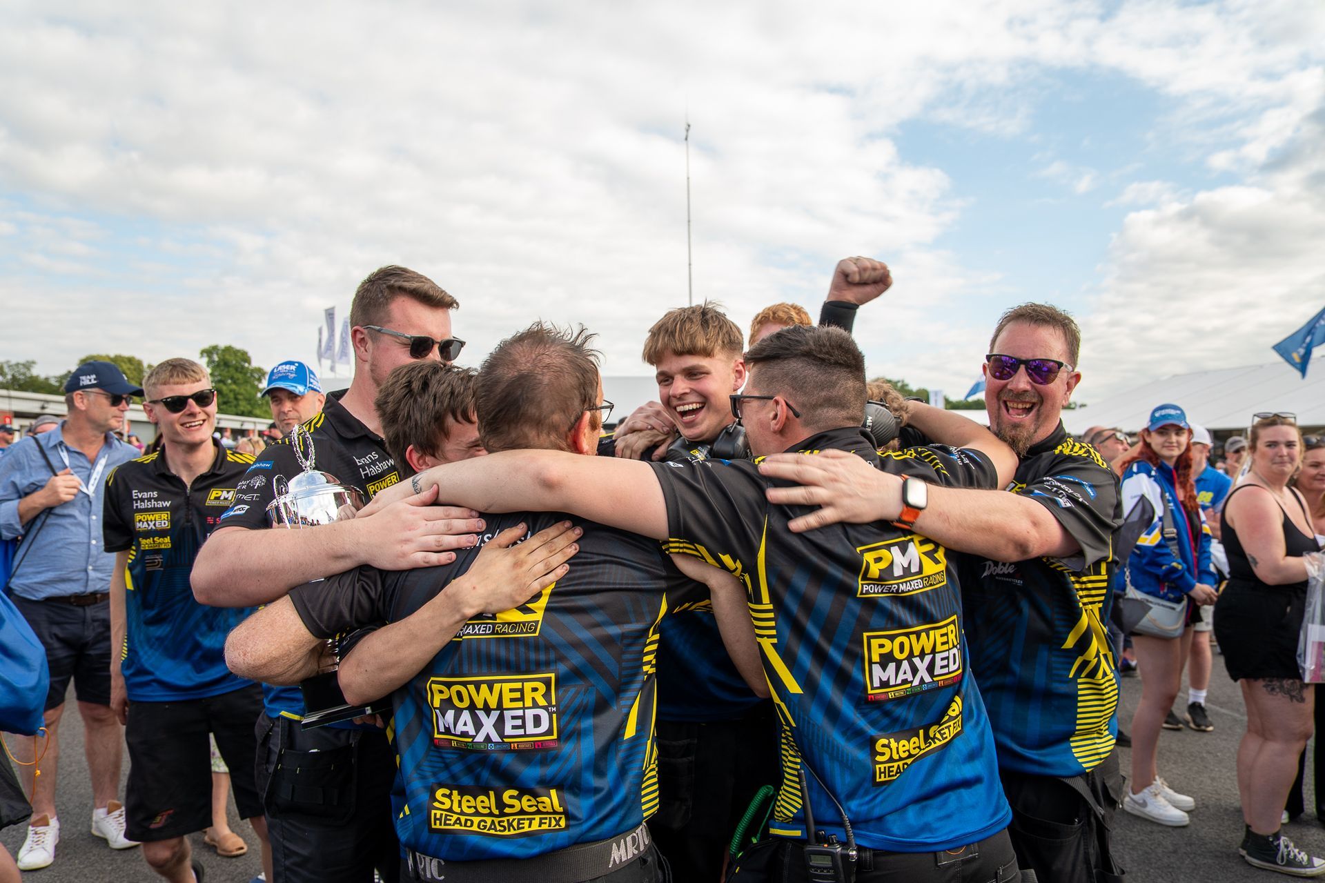 A group of men are hugging each other in a huddle.