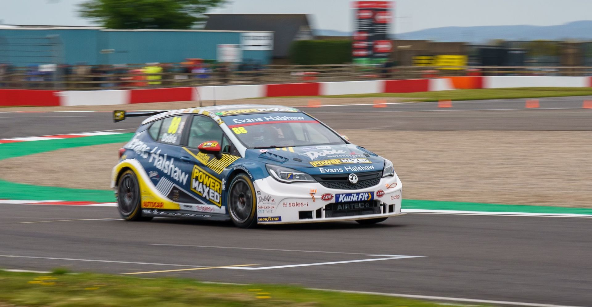 A race car is driving down a race track.