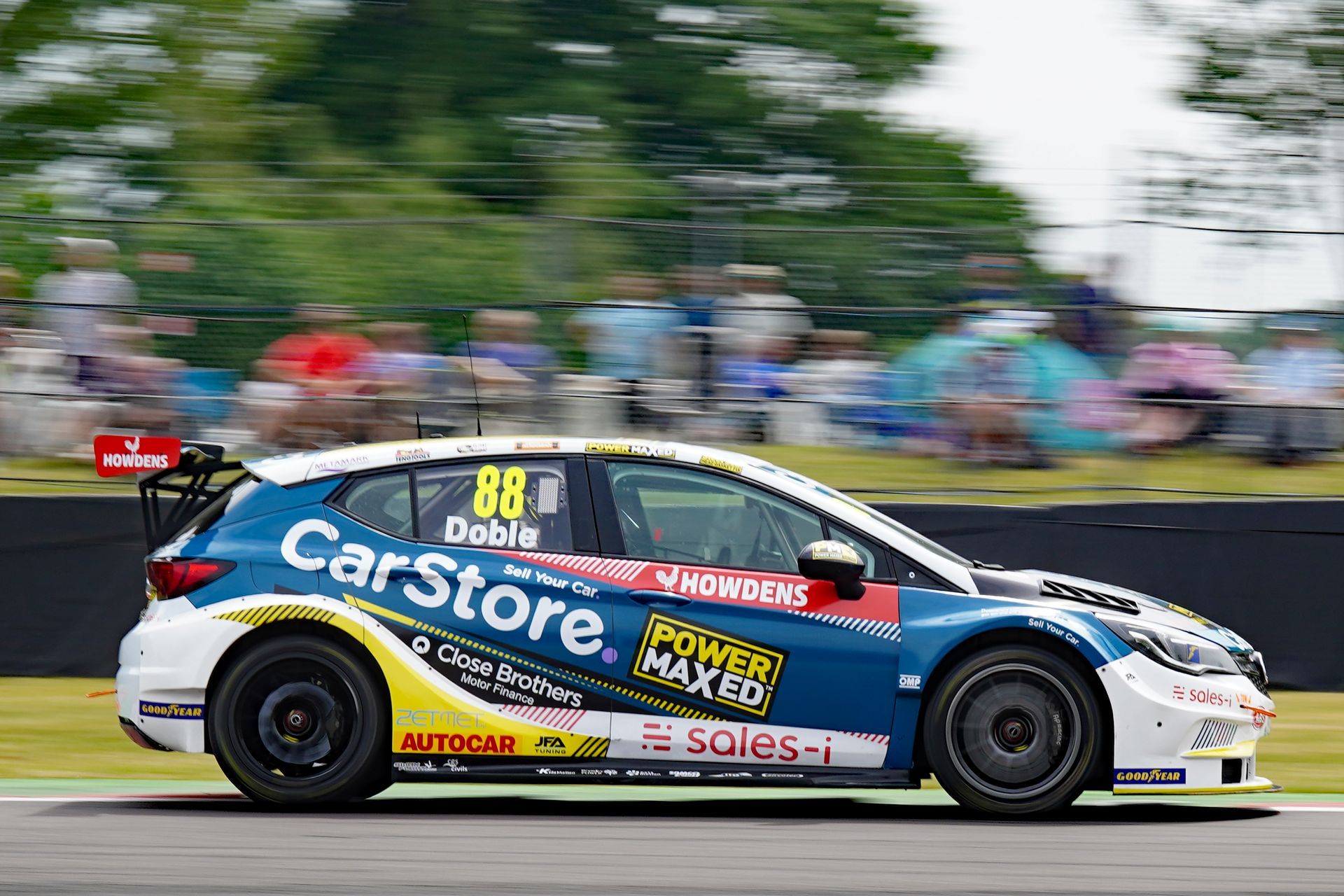 A race car is driving down a race track.