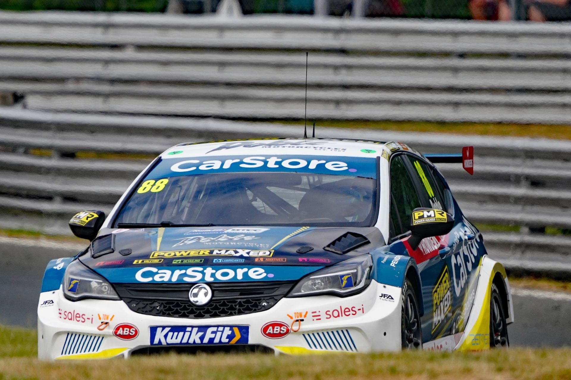 A race car is driving down a race track.