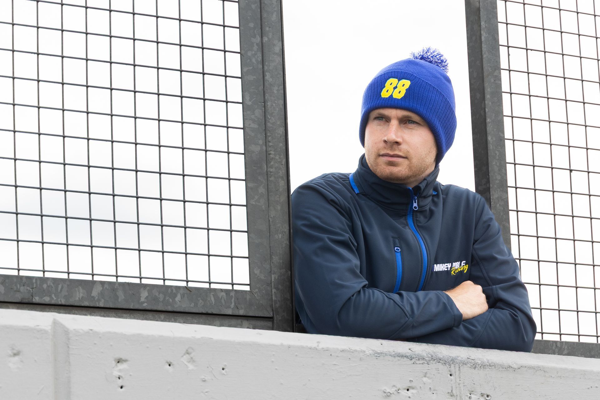 Mikey Doble overlooking Donington Park Circuit whilst wearing #88ARMY beanie