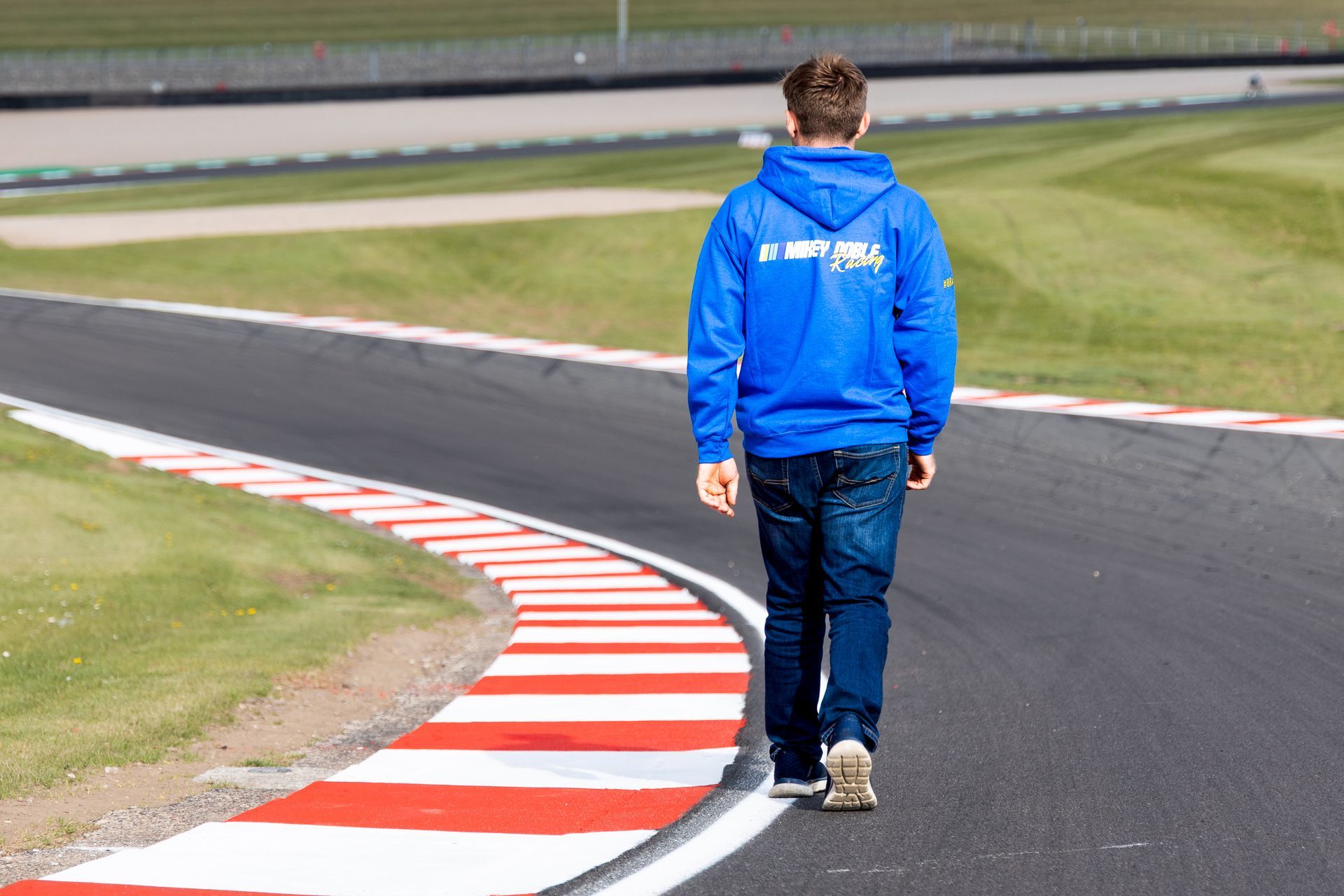 Mikey Doble wearing #88ARMY Zip Hoodie on corner at Donington Park