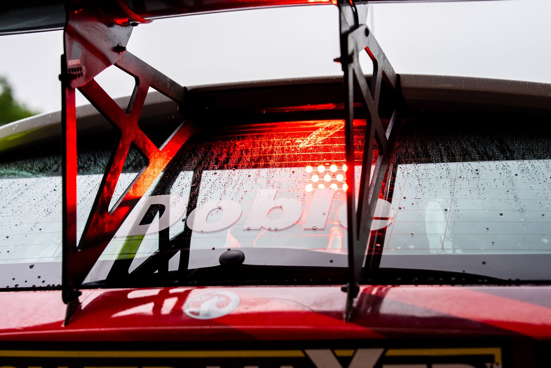 Mikey Doble's BTCC car rear shot in rain with brake light